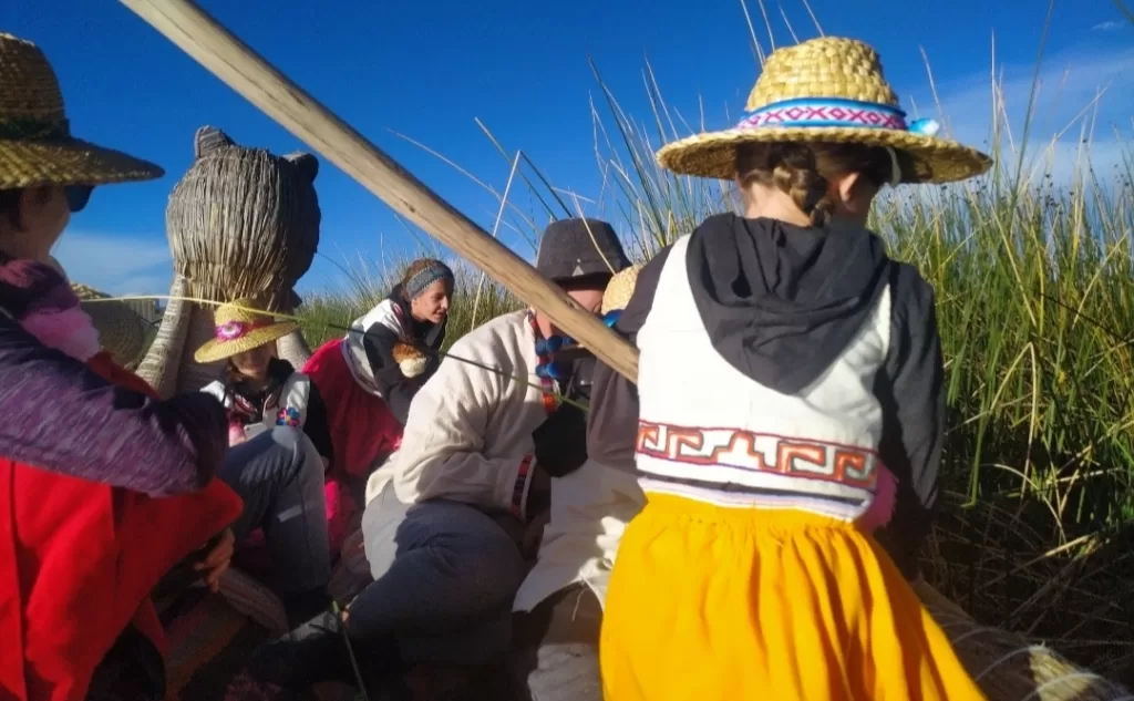 A little girl cutting reeds using a local tool