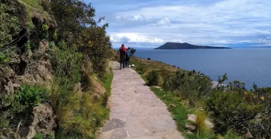 Hiking the stone path in Taquile with Amantani in the distance