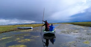 Rowing a wooden boat on Lake Titicaca