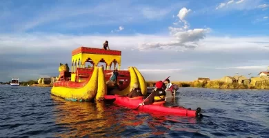 Kayaking behind the reed boat at Uros